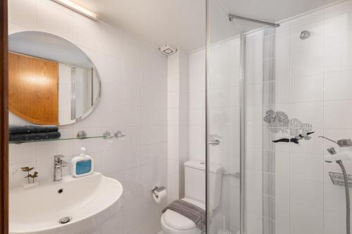 a bathroom with a shower and a toilet and a sink at Villa KATHERINA G in Schinias