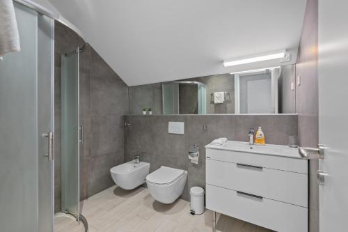 a bathroom with a toilet and a sink and a shower at House Degenia in Lovinac