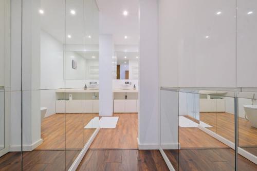 a kitchen with a glass table and white walls at Luxury Duplex in Benfica 15 Min to Airport in Lisbon