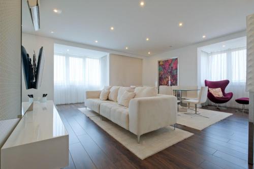 a living room with a couch and a table at Luxury Duplex in Benfica 15 Min to Airport in Lisbon