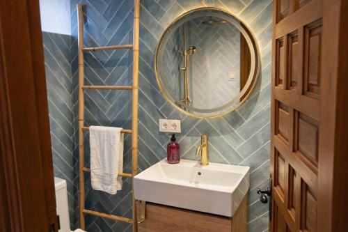 a bathroom with a sink and a mirror at El Refugio de Redo - balcón a los Picos de Europa in Camaleño