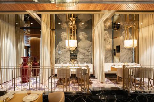 a restaurant with tables and a statue in the background at Rocks Hotel & Casino in Kyrenia