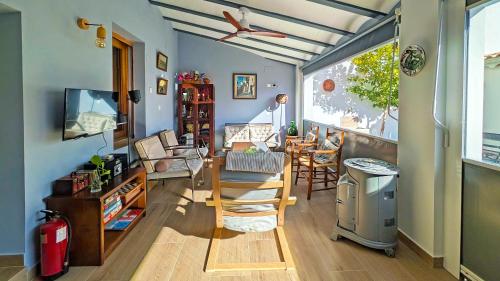a living room with a ceiling fan and a table at La Vieja Parra in La Puerta de Segura