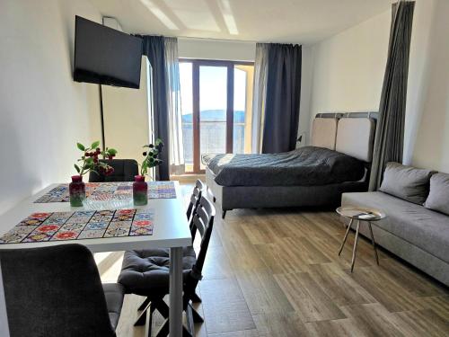 a small living room with a table and a couch at Sunny studio in Shartrez in Shkorpilovtsi