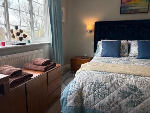 a bedroom with a large bed and a window at Were House Warminster in Warminster