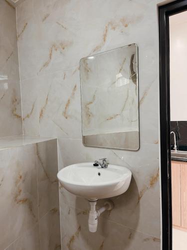 a bathroom with a sink and a mirror at Villa with jacuzzi, Damar Ningrum 5 in Panjadakan
