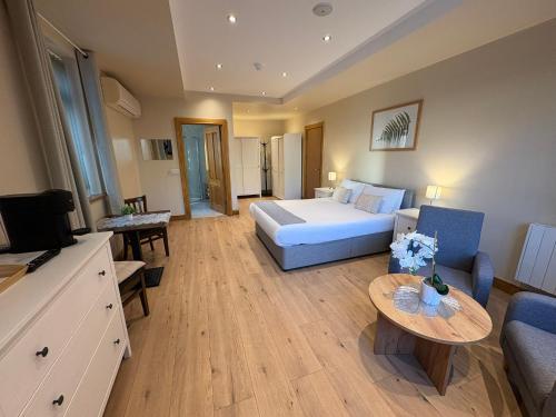 a bedroom with a bed and a couch and a table at Feeney's Audubon Lodge in Galway