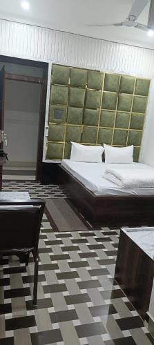 a bedroom with two beds and a table in a room at Hotel Laxmi villa in Naini