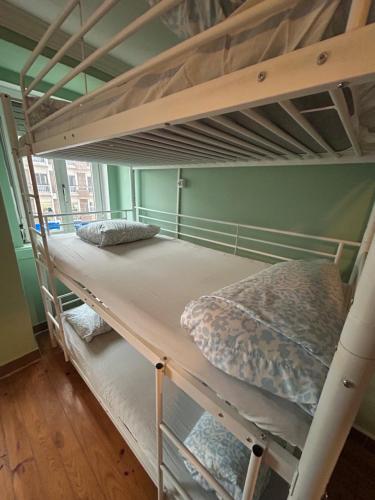 a couple of bunk beds in a room at Auristelas Hostel in Lisbon
