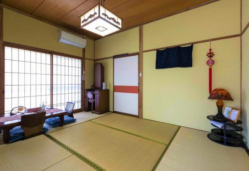 a room with a room with a table and a room with a room at An old house with a fire pit for rent Guesthouse Yukarian - Vacation STAY 87627v in Egita