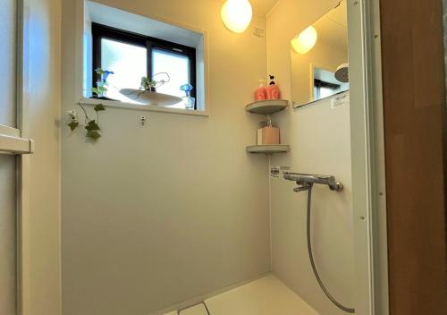 a bathroom with a shower and a sink at An old house with a fire pit for rent Guesthouse Yukarian - Vacation STAY 87627v in Egita