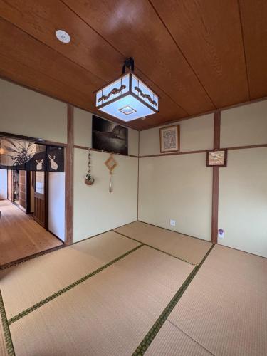 an empty room with a large rug on the floor at An old house with a fire pit for rent Guesthouse Yukarian - Vacation STAY 87627v in Egita