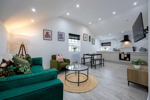 a living room with a couch and a table at The Knutsford loft in Knutsford