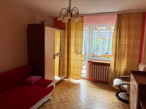 a living room with a couch and a window at House with garden For 8 people in Suwałki