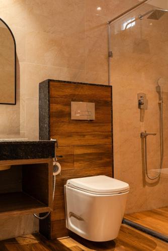 a bathroom with a toilet and a shower at The Hue House in Sibsāgar