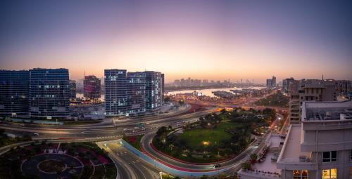 a city at night with traffic on a highway at Reya Creek Hotel in Dubai