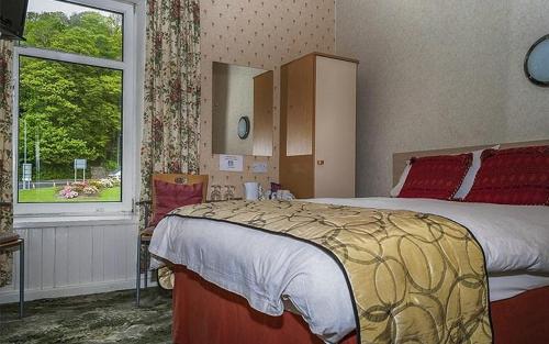 a bedroom with a bed and a large window at Hamilton House Guest House in Oban