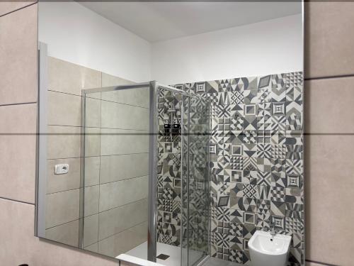 a bathroom with a shower with a toilet and a sink at Casa Vacanza Iolanda in Mafalda