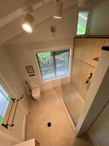 an overhead view of a bathroom with a window at Snows Creek Retreat - The Pool House in Upper Coopers Creek