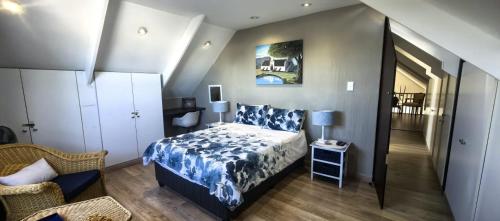 a bedroom with a bed with a blue and white bedspread at The Gables in Grotto Bay