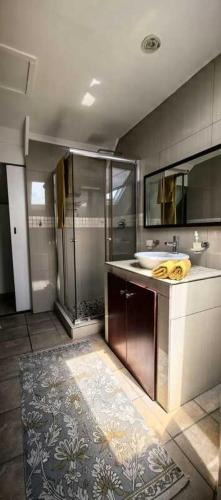 a large bathroom with a sink and a shower at The Gables in Grotto Bay