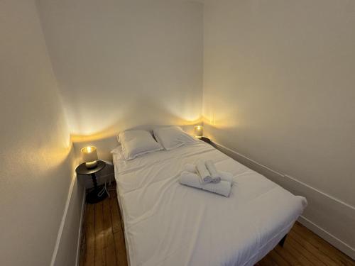 a bed with two towels on it with lights on it at T2 Hyper centre Senlis in Senlis