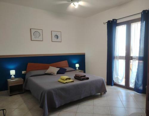 a bedroom with a bed with two towels on it at Bed & Breakfast Gli Alisei in Siniscola