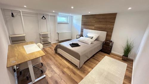 a bedroom with a bed and a desk in it at Ferienwohnung Nella in Paderborn
