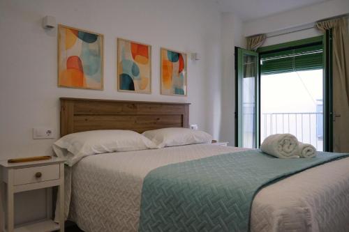 a bedroom with two beds next to a window at La casita verde in Cazorla