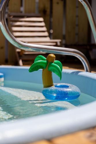 a toy palm tree in a swimming pool at Cozy house with sea view! in Luquillo