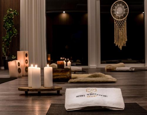 a room with candles and a towel on the floor at Hotel Winterberg Resort in Winterberg