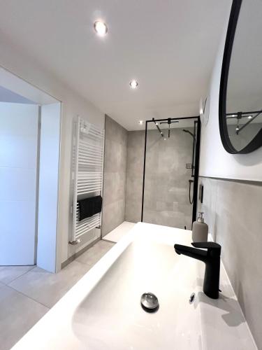 a bathroom with a shower and a bath tub at An der Grüh in Großsolt