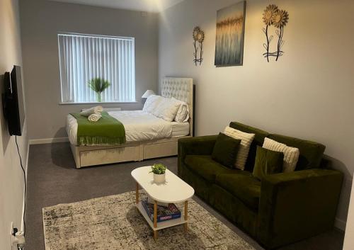 a living room with a couch and a bed at Rochester - Modern Flats Near Castle, Strood - Medway 1 or 2 Bedroom in Wainscot