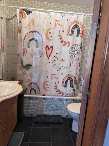 a bathroom with a shower curtain and a toilet at Malaga Mijas Costa Pool Nuevo Piso in Mijas Costa