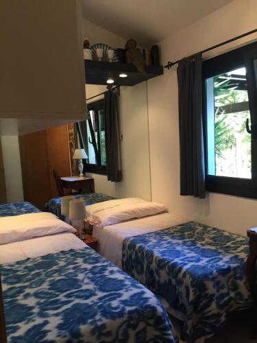 a hotel room with two beds and a window at La Becada de las Landas in Seignosse