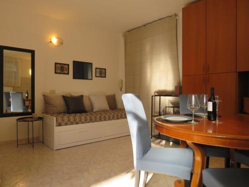 a living room with a bed and a table and a dining room at Civico 55 in Casale Torre San Giovanni