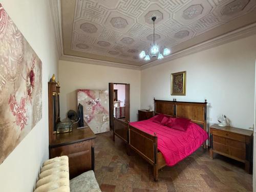 a bedroom with a bed with a red bedspread at B&B Falconi in Fermo