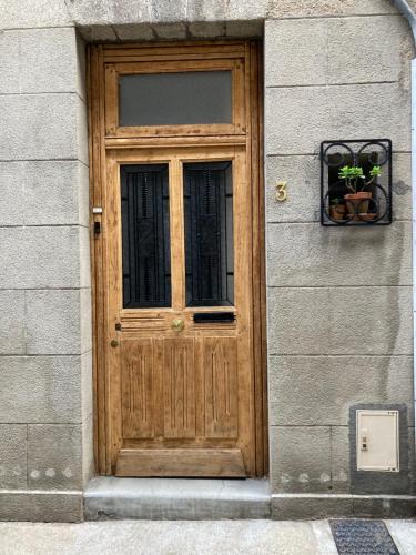 a wooden door on the side of a building at Studio à l'entrée de ma maison in Aubusson