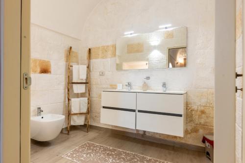 a white bathroom with a sink and a mirror at Casa Roma 78 Traditional Stone House in Monopoli Center in Monopoli