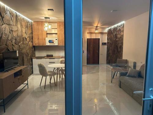 a kitchen and a living room with a couch and a table at Touch the Coast in Batumi