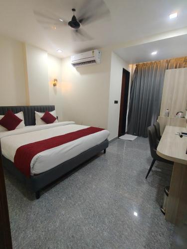 a hotel room with a bed and a desk at Hotel The Crown Prince in Jaipur