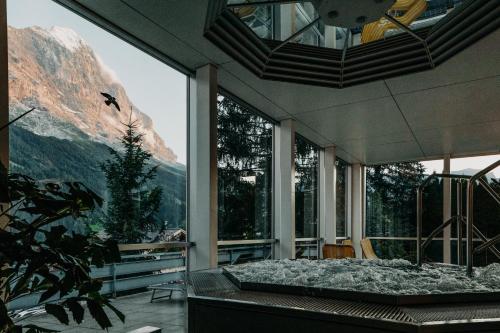 a bedroom with a bed with a view of a mountain at Parkhotel Schoenegg in Grindelwald