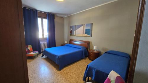 a bedroom with two beds and a window at Terry House in Sirmione