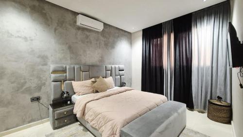 a bedroom with a large bed and a large window at Modern Design Villa Private Pool Marrakech in Marrakesh
