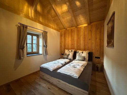 a bedroom with a bed in a room with a window at Ferienhaus Steinschlössl in Mühldorf