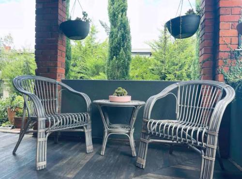 two chairs and a table on a patio at The Residence - Spacious 4-Bed Tenterfield Home in Tenterfield