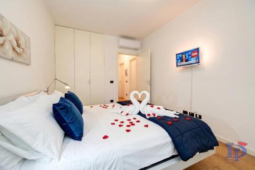 a bedroom with a white bed with red hearts on it at The Wind Rose renovation 2025 DesenzanoLoft Official Partner Homes & Villas by Marriott Bonvoy in Desenzano del Garda