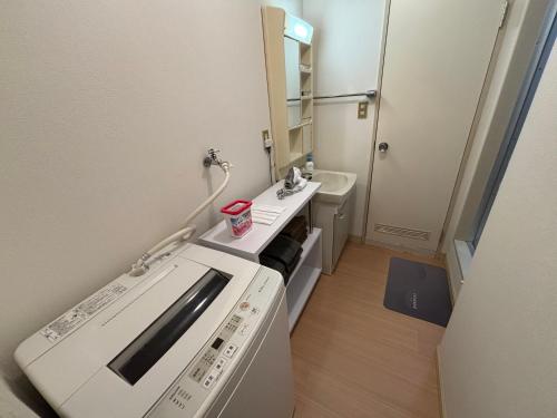 a small bathroom with a sink and a toilet at ITO-STAY Apartment Hotel 阿蘇くまもと空港 #201 in Ozu