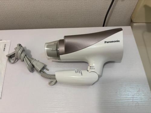a hair dryer sitting on top of a box at ITO-STAY Apartment Hotel 阿蘇くまもと空港 #201 in Ozu