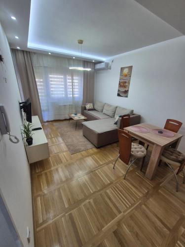 a living room with a couch and a table at Apartman Mina in Požarevac